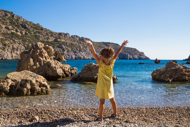 Girl relaxing against blue sky and sea background. 