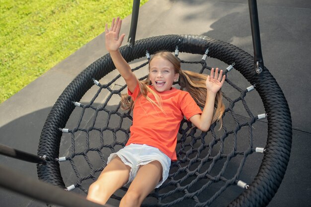 Girl resting after play and waving her hand