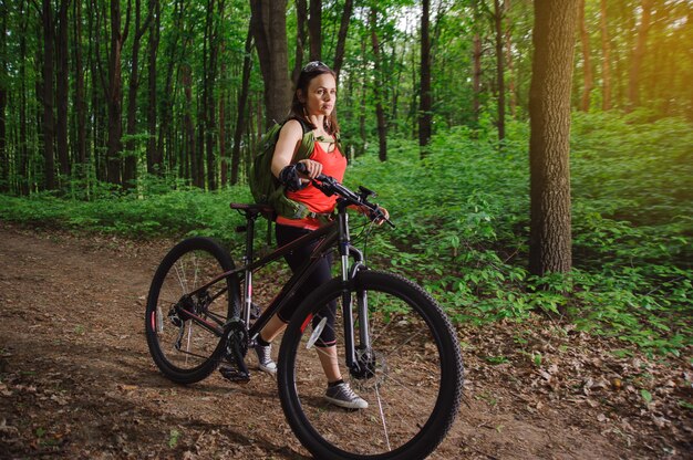 Girl riding a bike in the woods