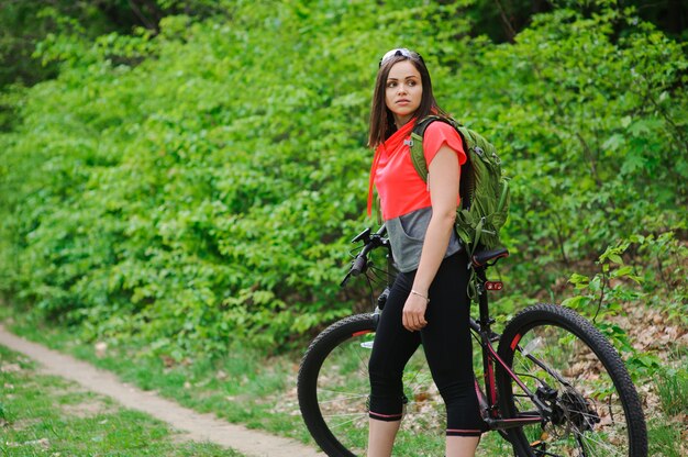 Girl riding a bike in the woods