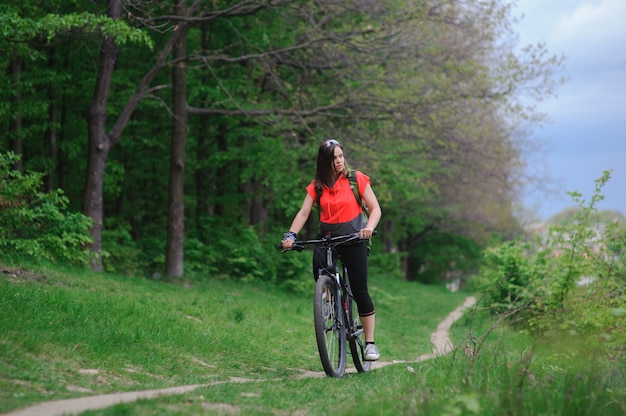 Girl riding a bike in the woods