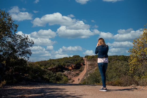 Girl on the road taking photos