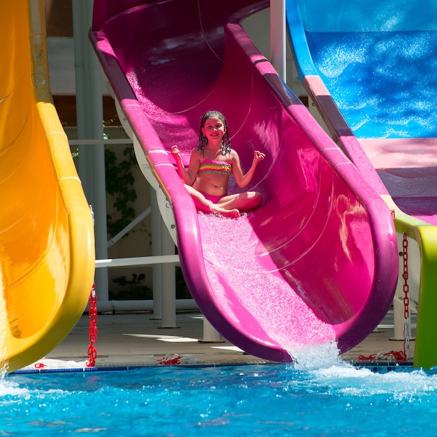 Girl rolls down the water slides at the water park