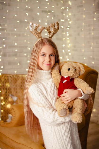 Girl in a room with Christmas decorations