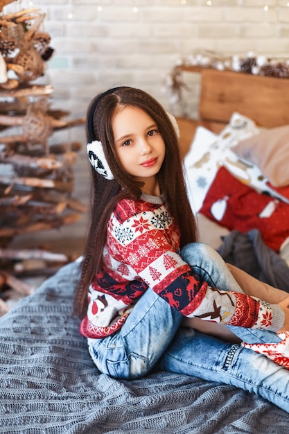 Girl in a room with Christmas decorations