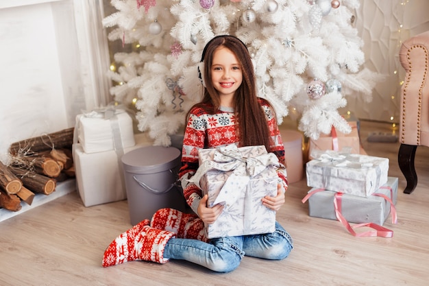 Girl in a room with Christmas decorations