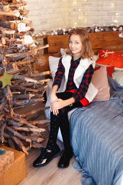 Girl in a room with Christmas decorations