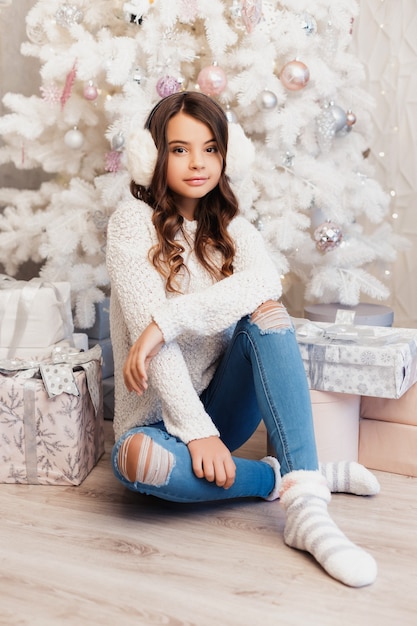 Girl in a room with Christmas decorations