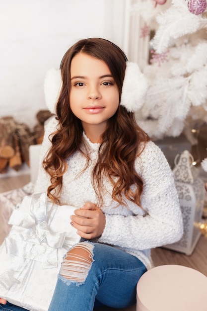 Girl in a room with Christmas decorations