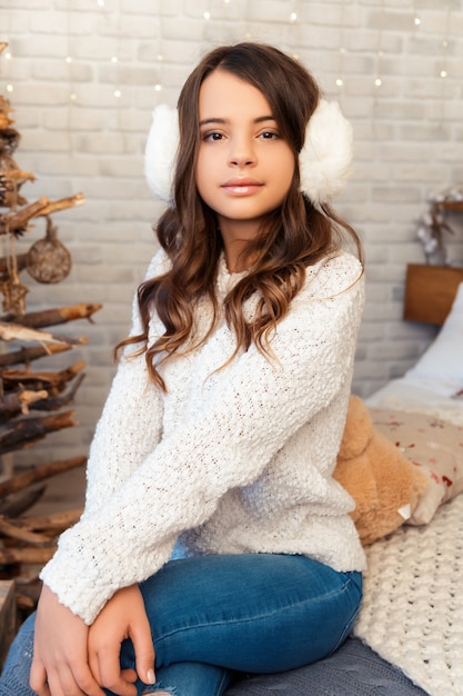 Girl in a room with Christmas decorations