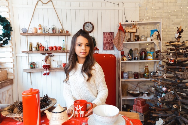 Girl in a room with Christmas decorations