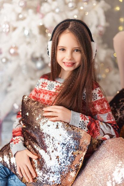 Girl in a room with Christmas decorations