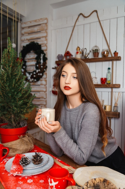 Girl in a room with Christmas decorations