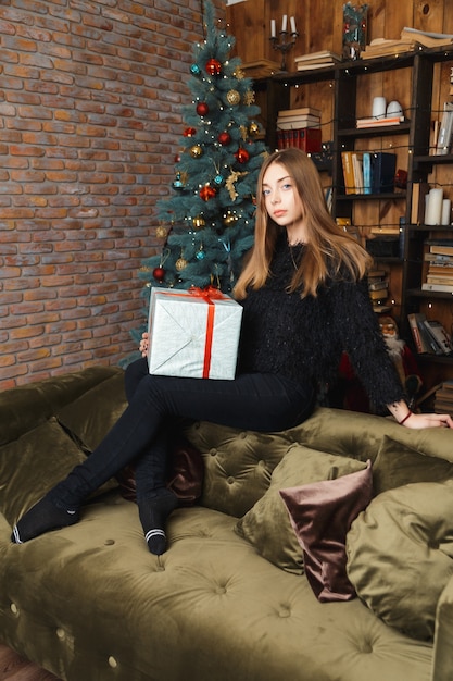 Girl in a room with Christmas decorations