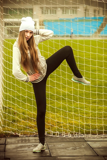 The girl runs and goes in for sports at the stadium