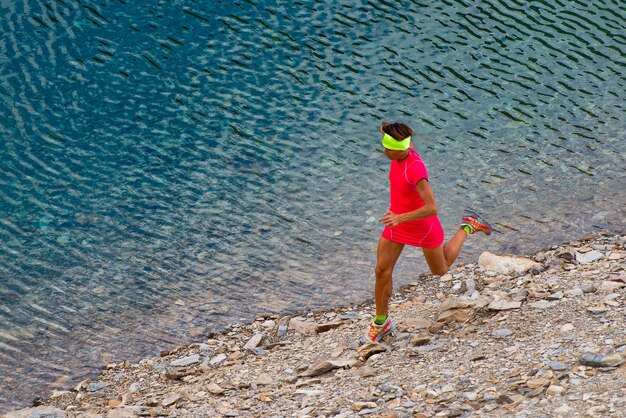 Girl runs near a lake