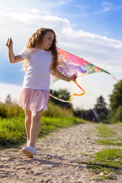 Girl runs with a kite