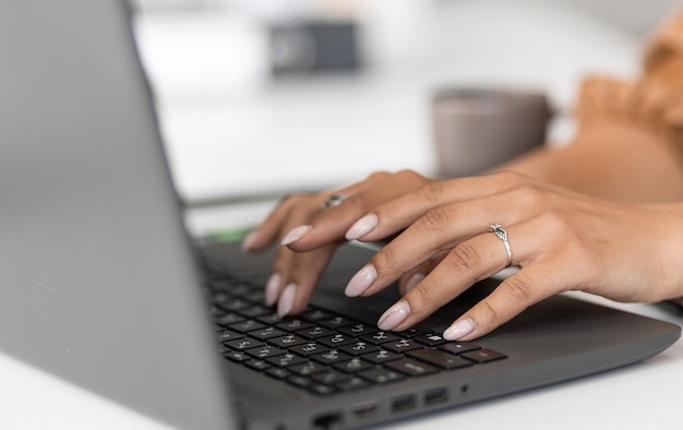 Girl's hands on a laptop keyboard