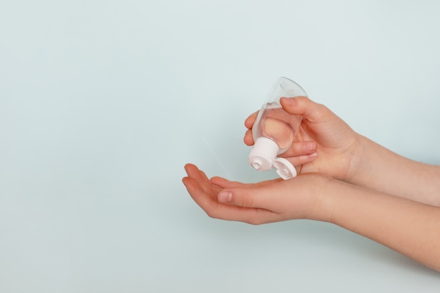 Girl's hands use antibacterial gel