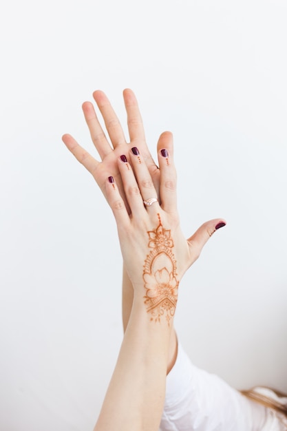 Girl's hands on white with henna pattern