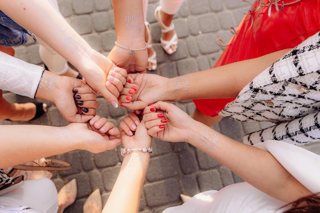 Girl's hands with a temporary tattoo of the bride's team. the concept of a bachelorette party.