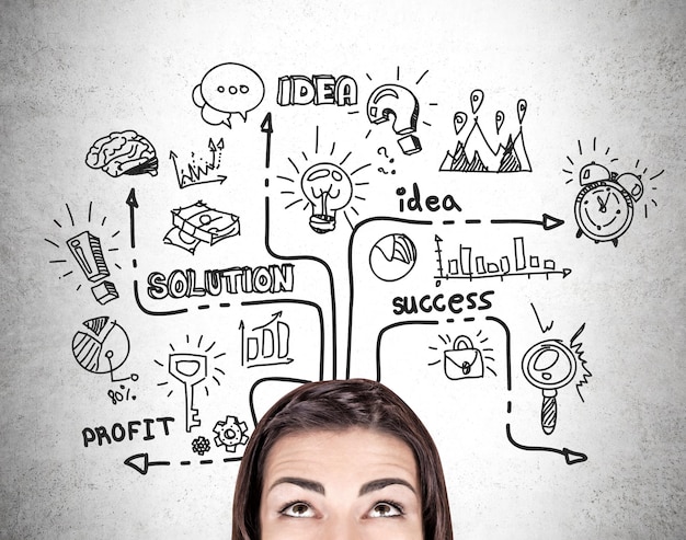 Girl's head and business icons on a concrete wall