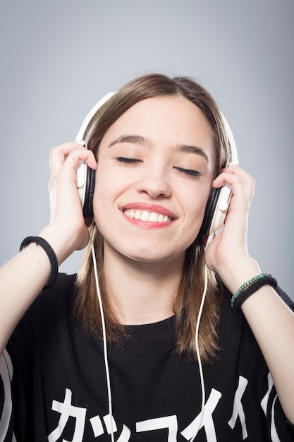 Girl's portrait listening to music with headphones