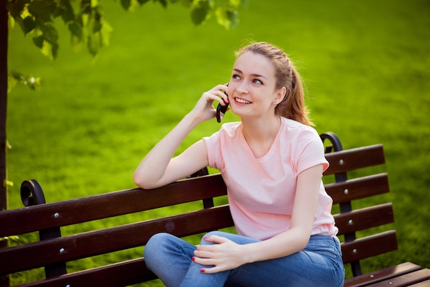 Girl says on the phone in the Park