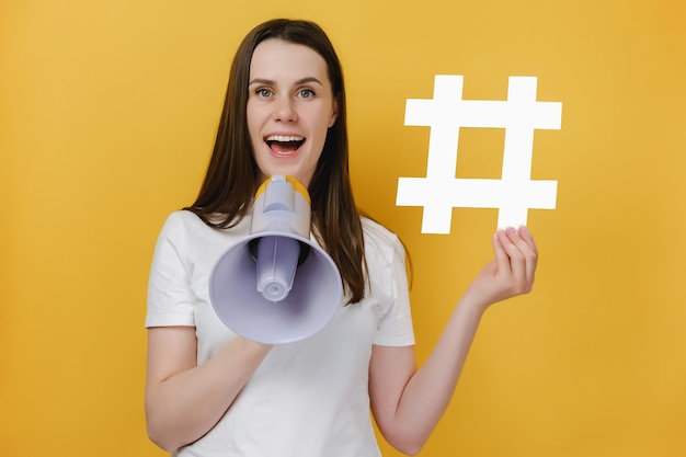 girl screaming in megaphone showing hashtag sign