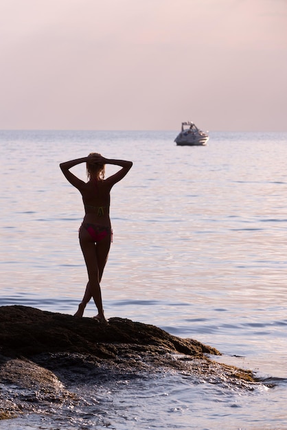 Girl on the sea in the background boats