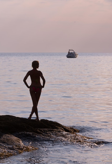 Girl on the sea in the background boats