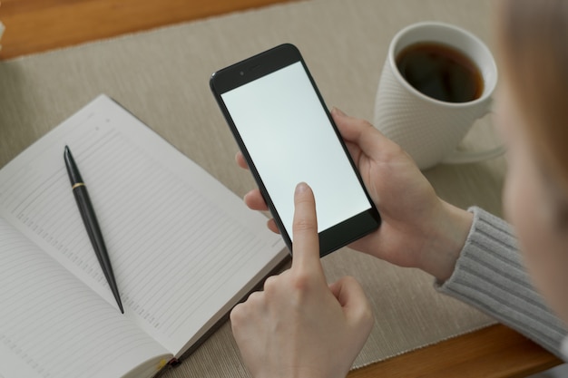 A girl searches for information on the Internet using a smartphone