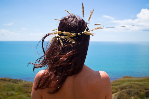 The girl on the seashore with a wreath on the head