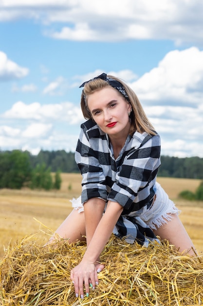 Girl on a sheaf of hay