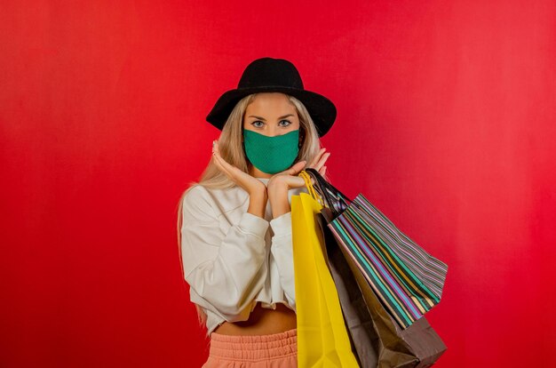 Girl shopping with green mask for prevention from coronavirus covid19 pandemic red background