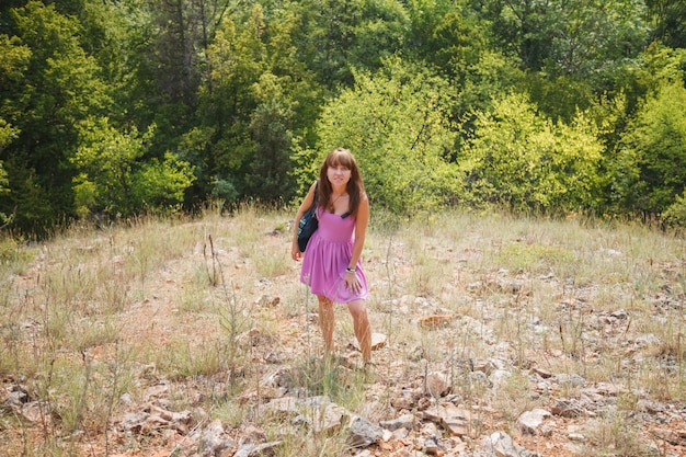 A girl in a short pink dress in a sunny Crimea