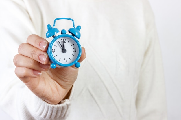 Girl showing an alarm clock