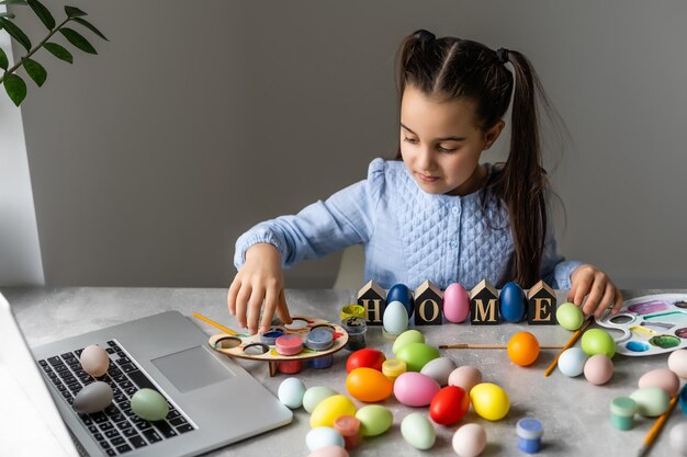 A girl showing her painted Easter Egg.