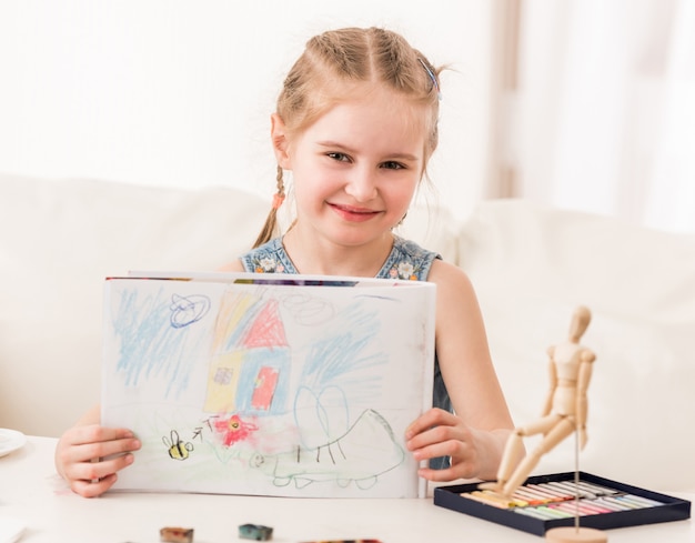 Girl showing pastel drawing