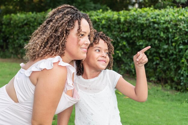 Girl showing something to her mother in the park