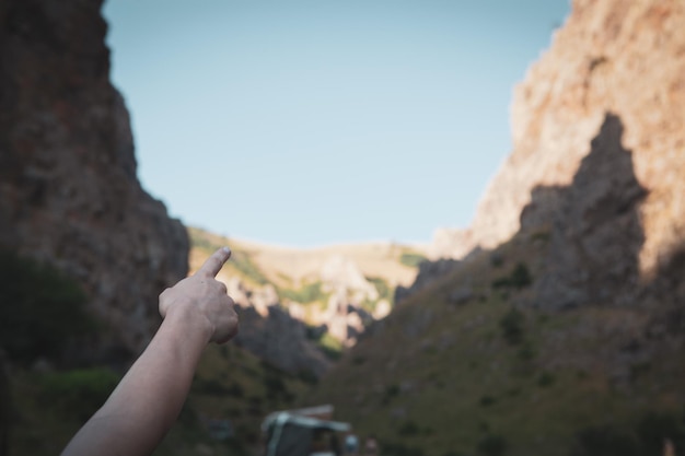 The girl shows a place in the mountains