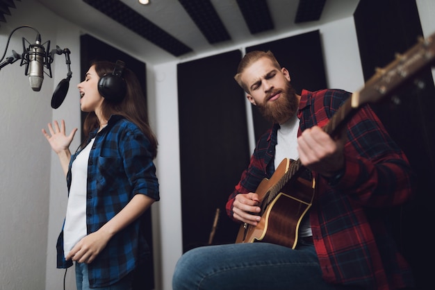 Girl sings, and the guy plays the guitar.