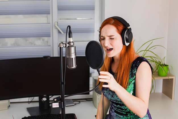 The girl sings at home using professional equipment