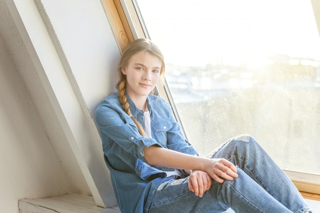 Girl sits on a window