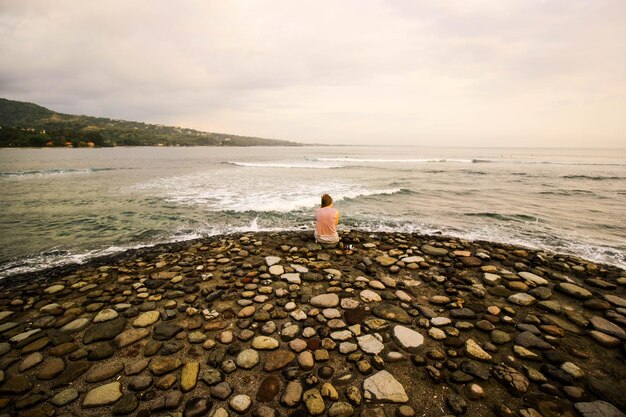 Girl sitting alone on the beach