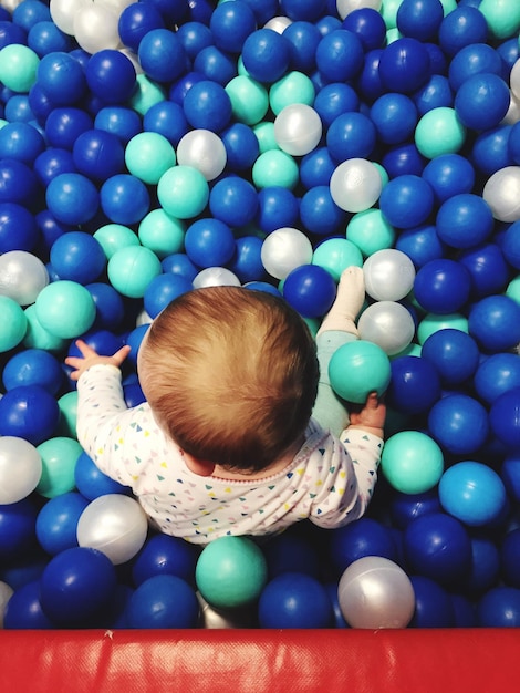 Girl sitting in ball pool