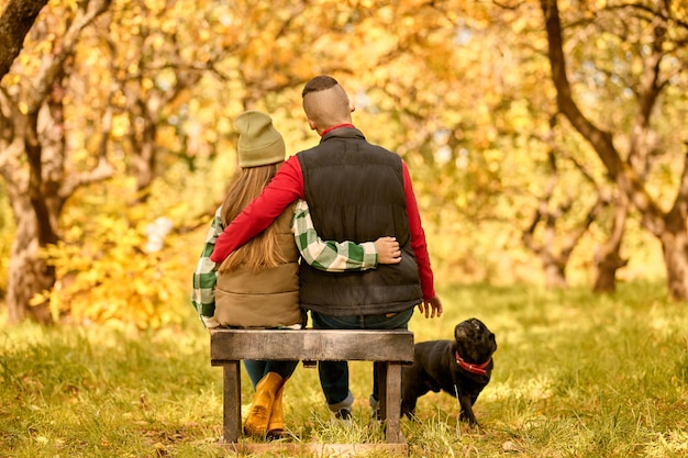 A girl sitting on the bench with her dad in the park