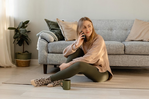 Girl sitting at home and talking on the phone