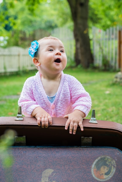 Girl sitting near suitcase