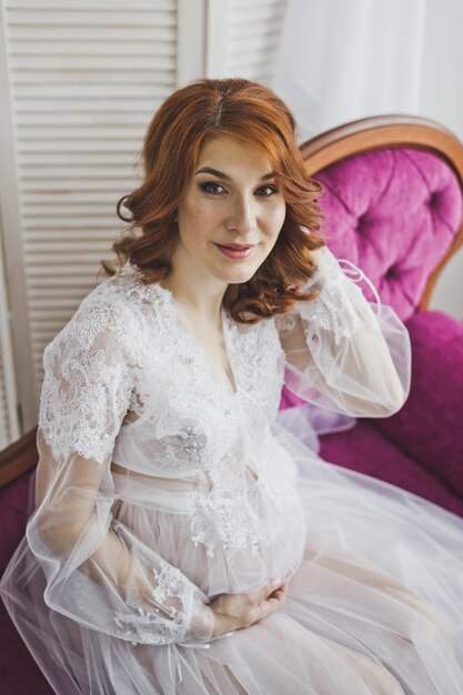 The girl in the sitting position on a pink couch 6822